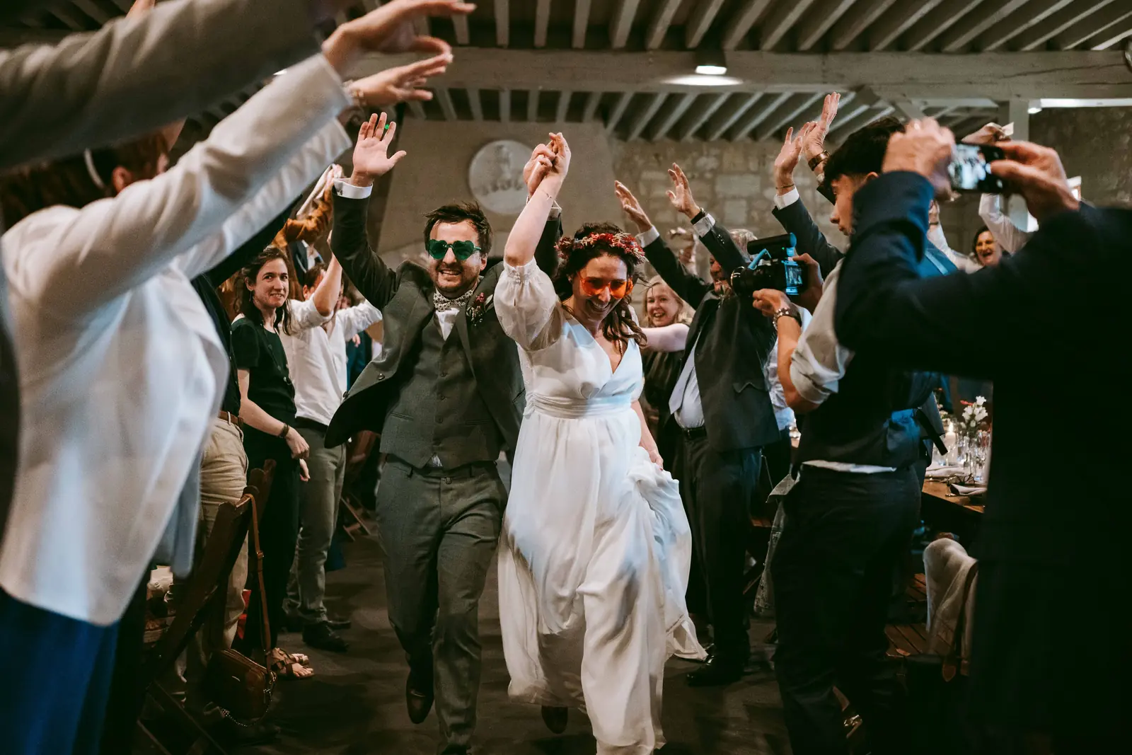 Entrée des mariés dans la salle, les invités bras levés