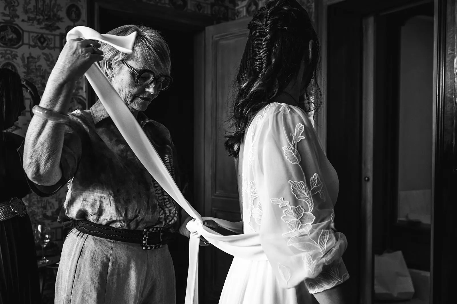 Black and white photo of the bride getting ready