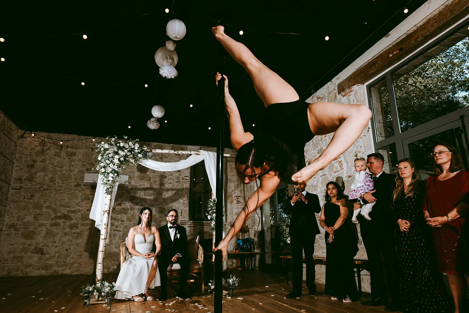 An aerial acrobat performing above the guests
