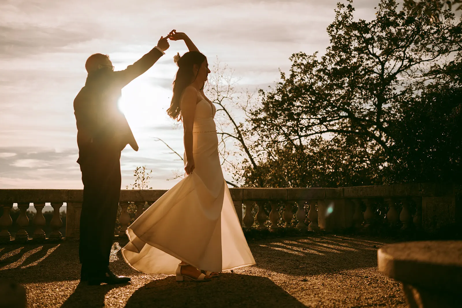 The groom twirling the bride on the terrace