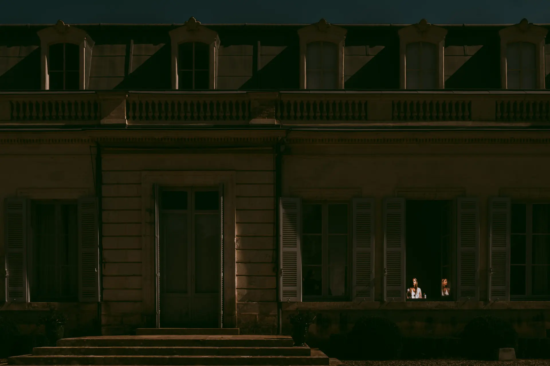 Façade de château illuminée la nuit d'un mariage